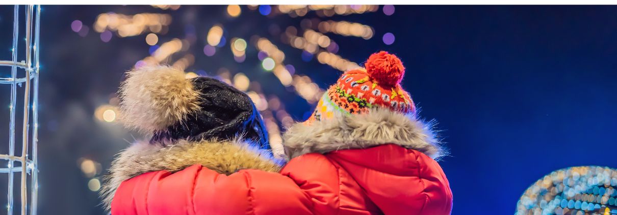 New Year in Swedish Lapland: A family dressed in winter clothing enjoys dazzling fireworks in the snowy Arctic landscape.