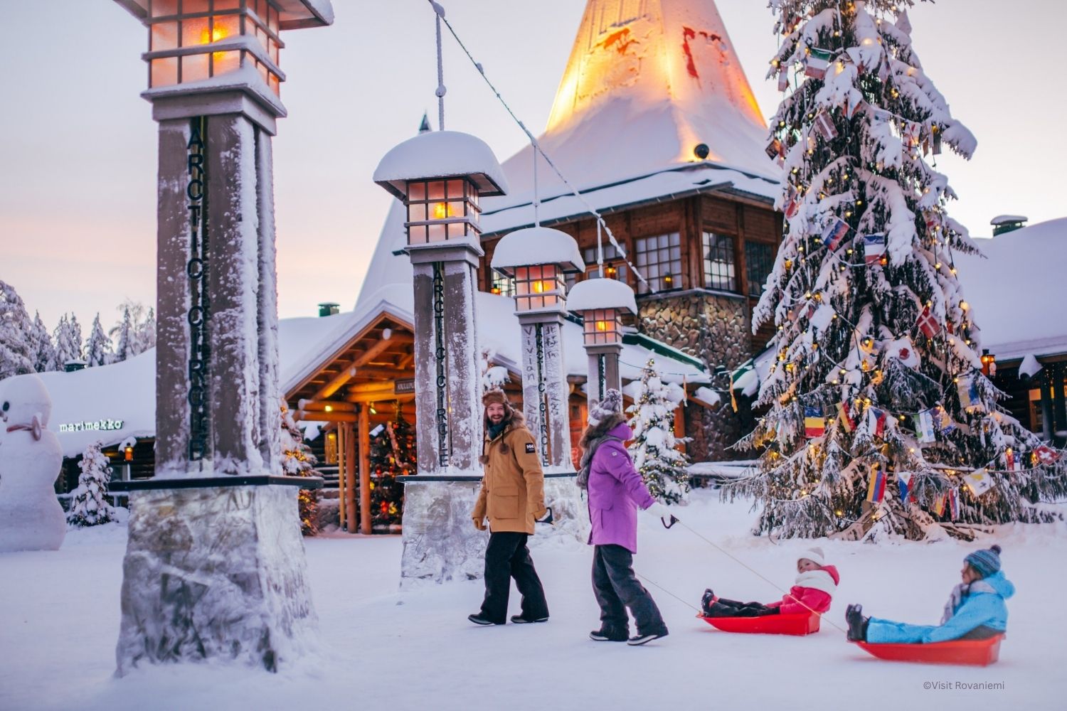Family crossing the arctic circle at Santa Claus Village in Rovaniemi Lapland Finland ©Visit Rovaniemi